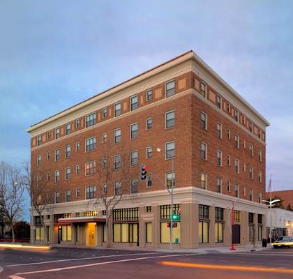 a large brick building on the corner of a street