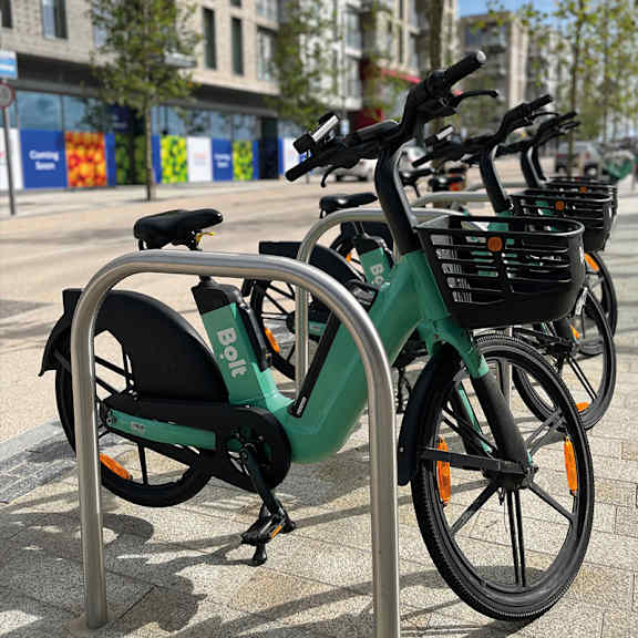 A green and black bike is parked next to a bike rack at Cherrywood Apartments, D18 VY3V, DUBLIN 18
