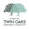 A logo for Twin Oaks Apartment Community features two trees.