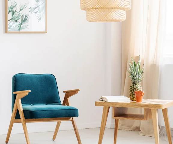 a living room with a blue chair and a wooden table