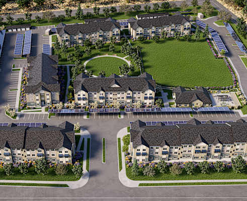 an aerial view of an apartment complex with a parking lot and lawn