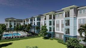 A modern apartment complex with a pool and green lawn.