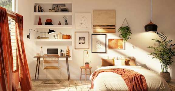 a bedroom with a bed and a desk and pictures on the wall