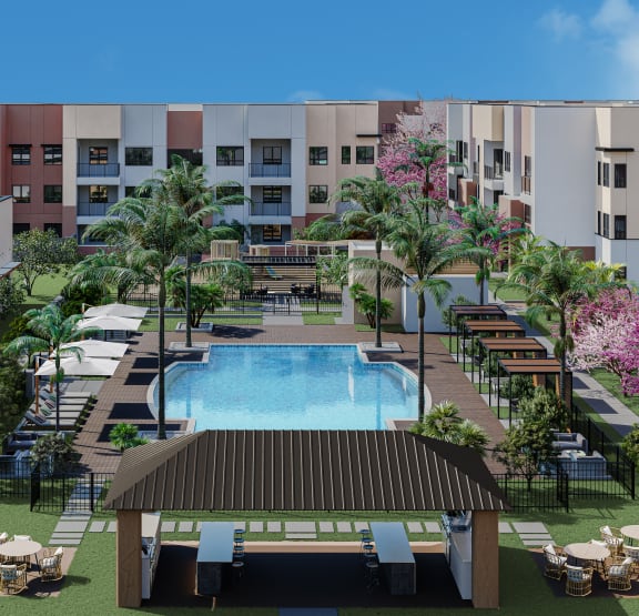 an aerial view of the resort style pool with lounge chairs and tables
