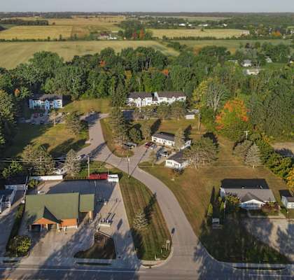 an aerial view of a neighborhood with houses and trees and a road