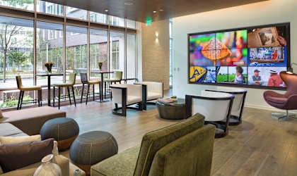a living room filled with furniture and a large window at The Pearl, Silver Spring, MD