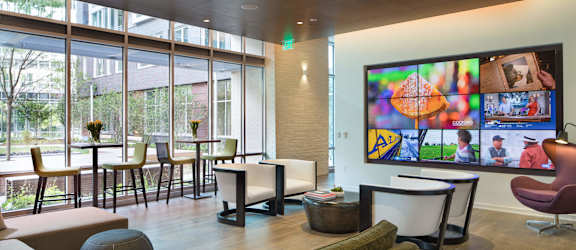 a living room filled with furniture and a large window at The Pearl, Silver Spring, MD