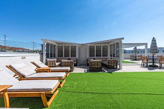 A sunny day at the outdoor seating area of a modern building. 605 Place Student Housing & Co-Living, St George Utah