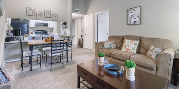 a living room and dining room with a couch and a table