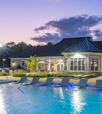 Outdoor Pool and Clubhouse at Dusk at Abberly Waterstone Apartment Homes, Stafford, VA 22554