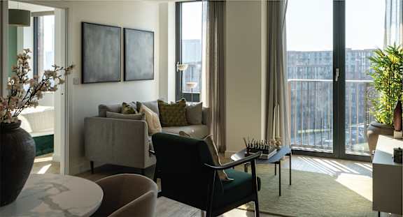 A living room with a couch, chairs, and a table.