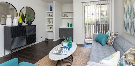 a living room with a ceiling fan and a sliding glass door