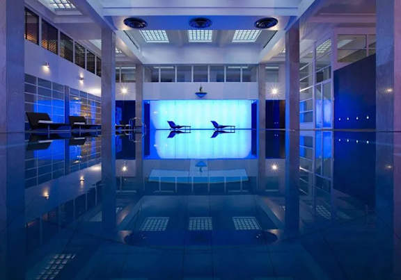 A control room with a large screen displaying an airplane.