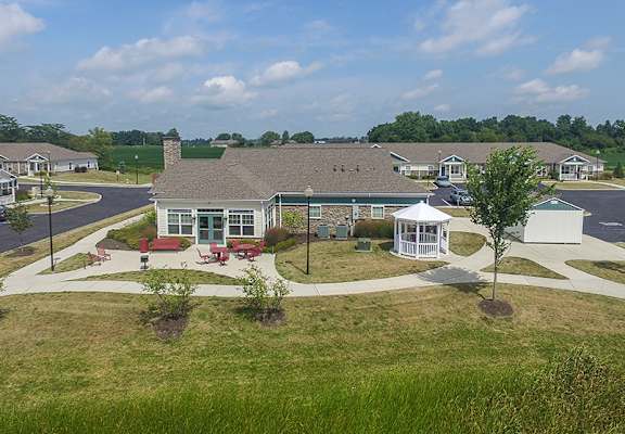 A building with a white gazebo in front of it.