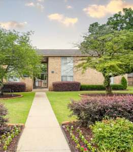 A building with a green lawn in front of it.