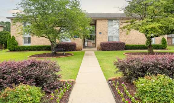 A building with a green lawn in front of it.