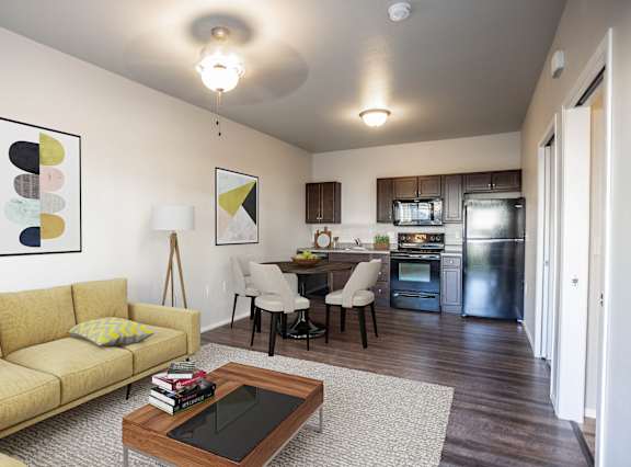 A modern living room with a yellow sofa and a coffee table.