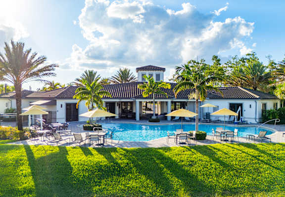 A large white house with a pool in the backyard.