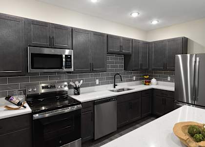 Kitchen with Black cabinets at Artisan, O’Fallon