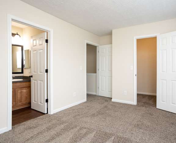 A room with a carpeted floor and white walls.