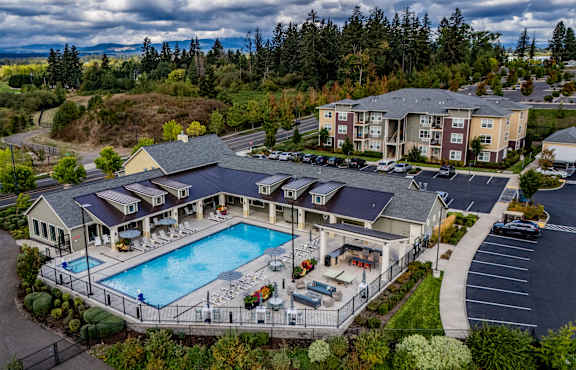 a birds eye view of a resort with a large swimming pool