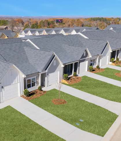 A row of houses with a clear blue sky above them.