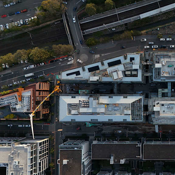 An aerial view of a city with buildings, roads, and trees.