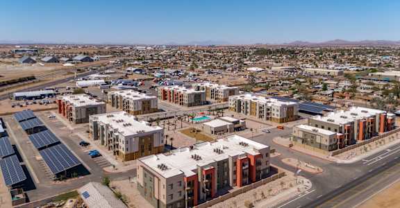 A large, modern housing development with solar panels on the roofs.