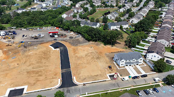 A construction site is surrounded by a residential area.