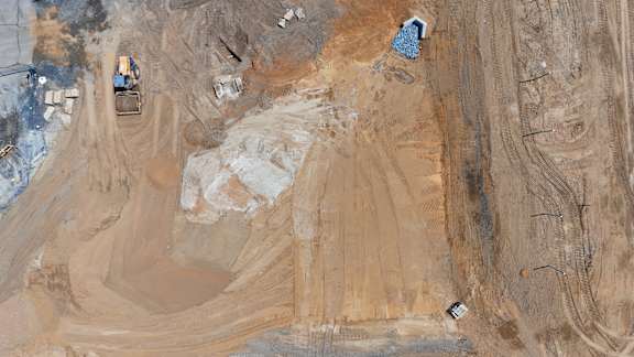 A construction site with a bulldozer and other machinery.