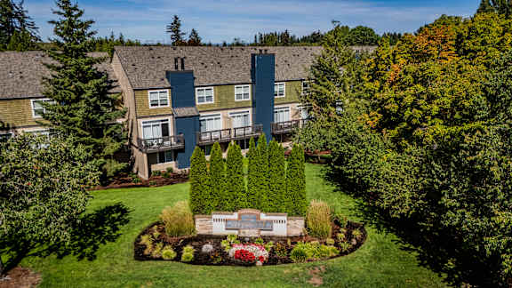 an aerial view of a large house with a yard and trees