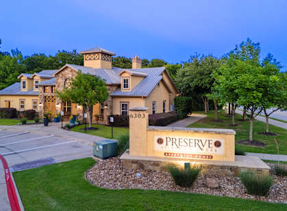 A large house with a sign that says Preserve in front of it.