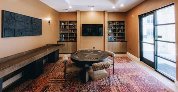 A room with a round table and chairs in the center. at Northwoods, Texas, 77388