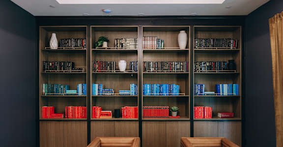 Library lounge with color coordinated book collection at Northwoods, Texas