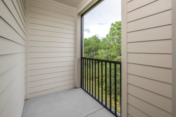 the view from the balcony of a home with a large window at The Haven at Lake Britt Apartments, Winter Garden, FL 34787