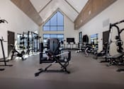 Thumbnail 15 of 52 - A gym with a variety of equipment including treadmills, weights, and exercise machines at Solhavn Apartments, American Fork, Utah