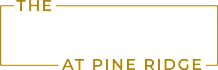 The image shows a black background with the words "The Village at Pine Ridge" written in white and gold.