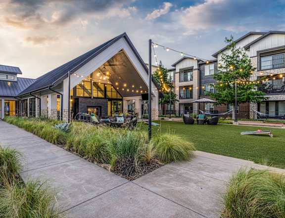 the yard of a home with a patio and a yard with grass