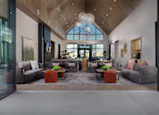 Thumbnail 10 of 52 - A modern living room with a high ceiling and a large window at Solhavn Apartments, American Fork, 84003