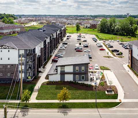 a view from the top of a building of a street with cars parked on the side of