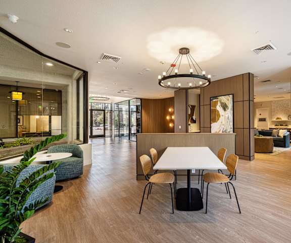 A modern dining area with a white table and chairs.