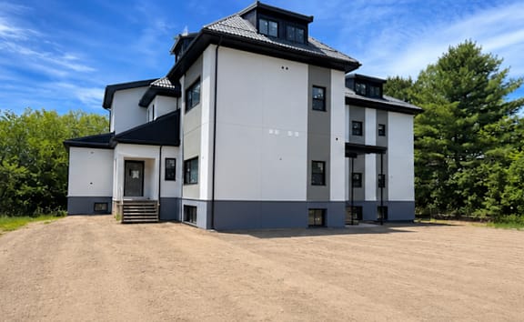 A building with a blue wall and a white door.