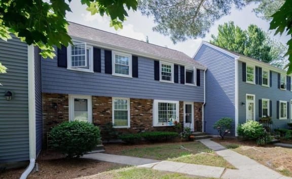 a blue house and a gray house with black shutters  at Arbor Commons, Ellington