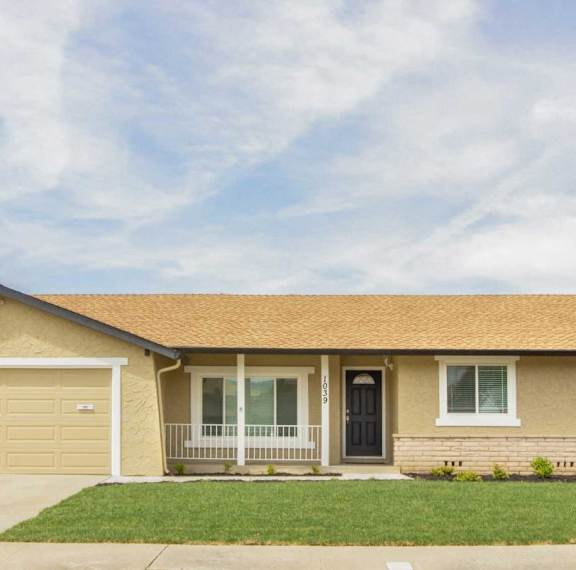 A house with a brown roof and a black door.
