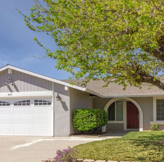 A house with the number 447 on the garage door.