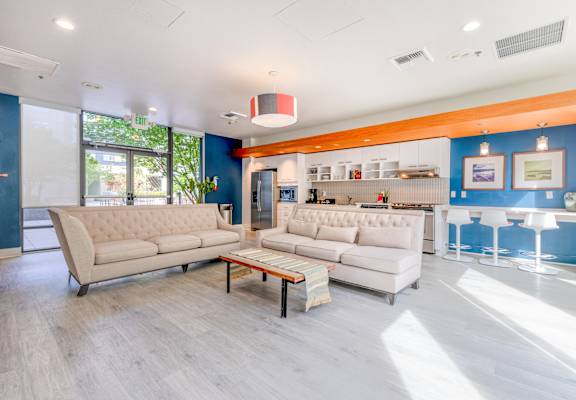 A modern living room with a white sofa and a wooden coffee table.