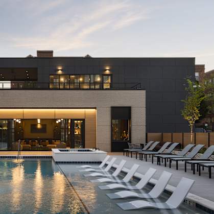 A modern house with a pool in front.