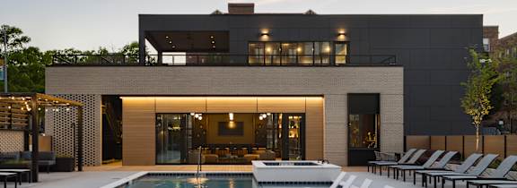 A modern house with a pool in front.
