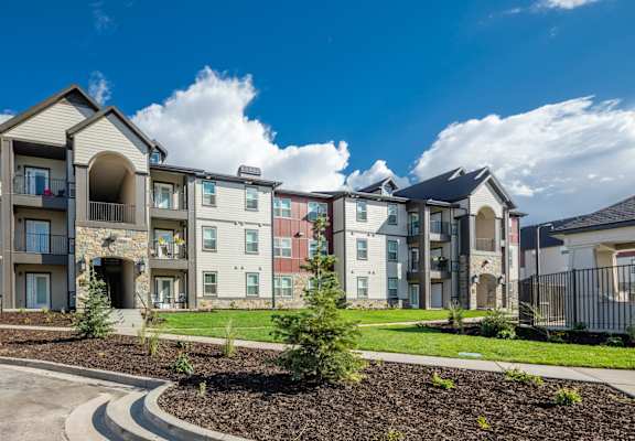 an exterior view of an apartment building on a sunny day