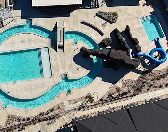 A large blue pool with a slide.